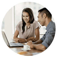Male Professonal Infront of Laptop, Explaining Webex Cloud to his Female Client