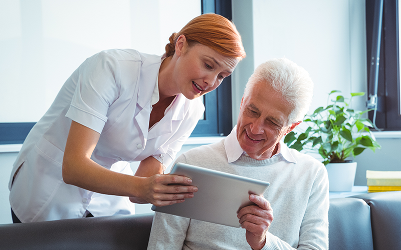 two elderly people using device