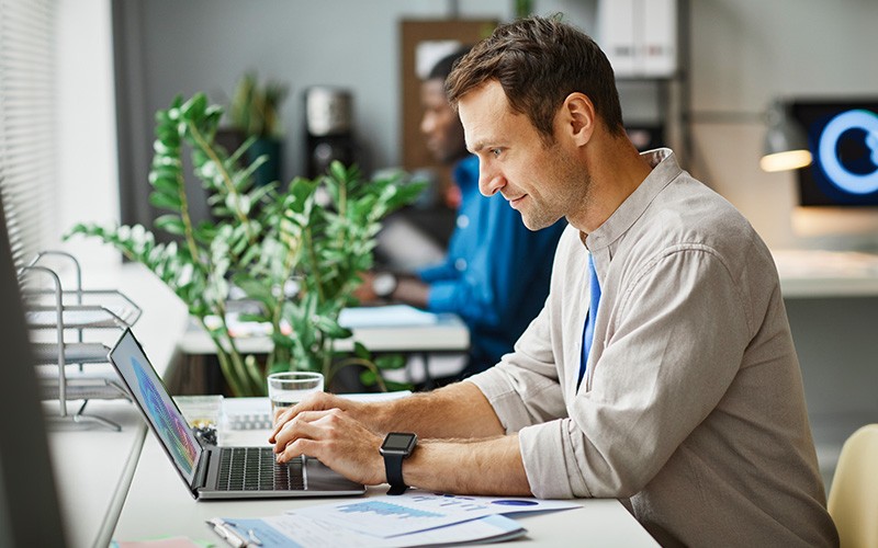 man typing on laptop