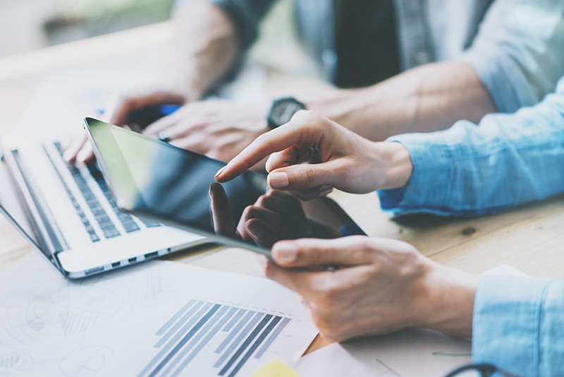 Business professionals using multiple mobile devices to have a meeting